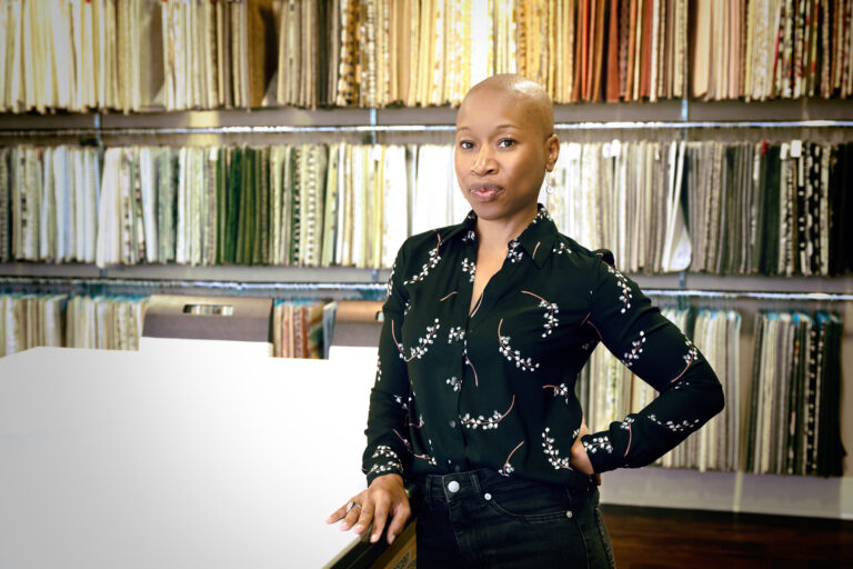 Kelli Braggs, founder of SanctuaryIAM, standing in a wellness-focused interior space during design process